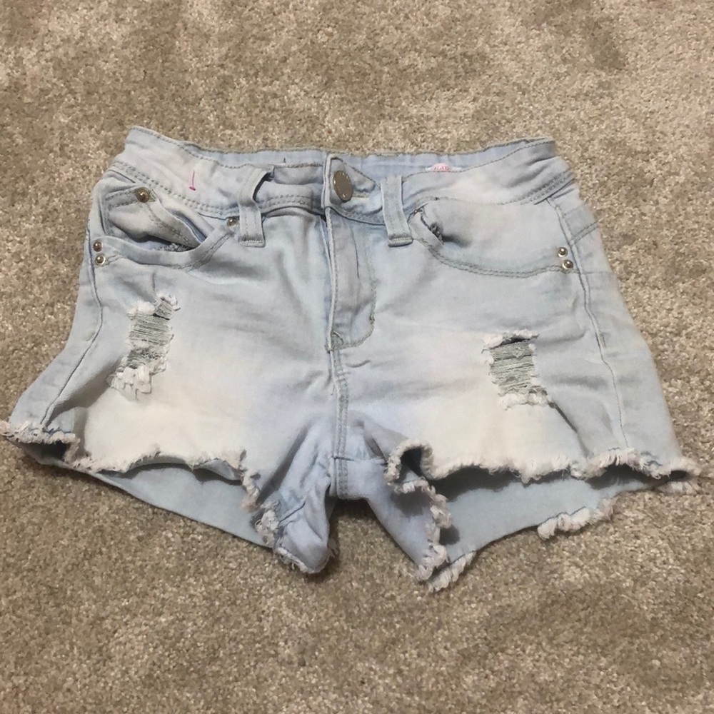 light blue denim shorts. low rise, distressed